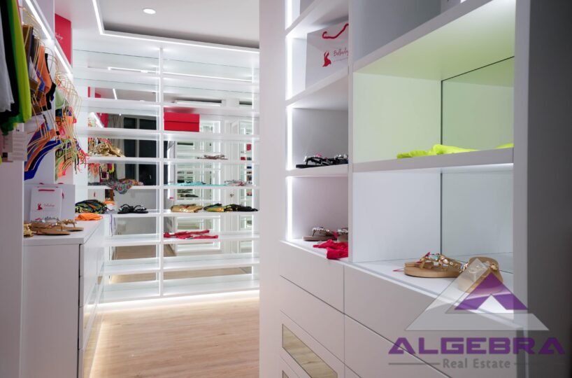 wardrobe room with algebra real estate logo