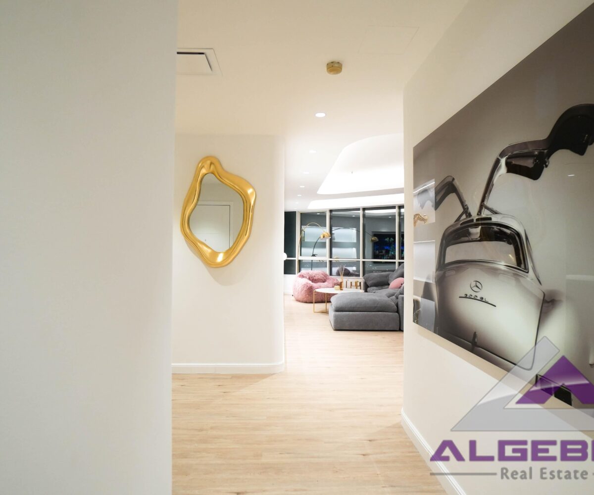 wall picture in livingroom with algebra real estate logo