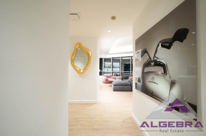 wall picture in livingroom with algebra real estate logo